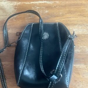 Elegant Black Crossbody Bag with Sun Emblem
